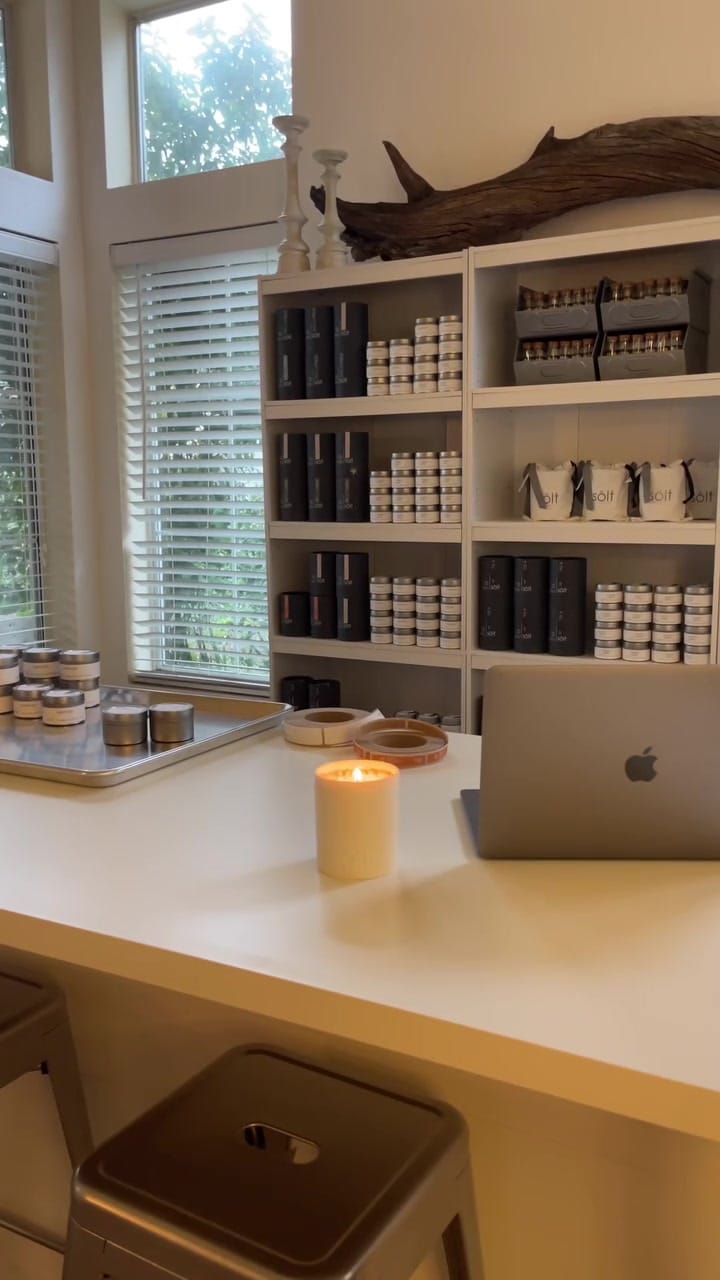 A candle burning on the studio desk